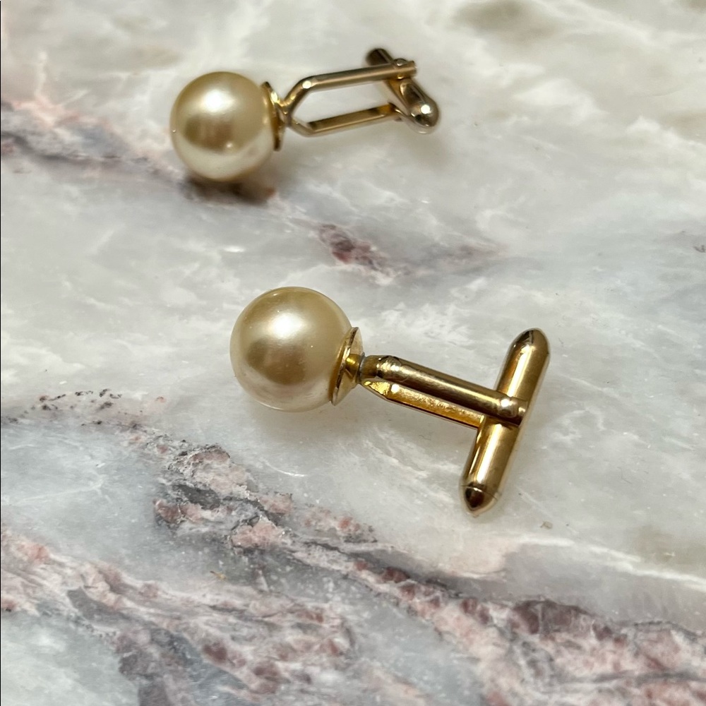 Cuff links gold toned with large pearls. MCM elegant.